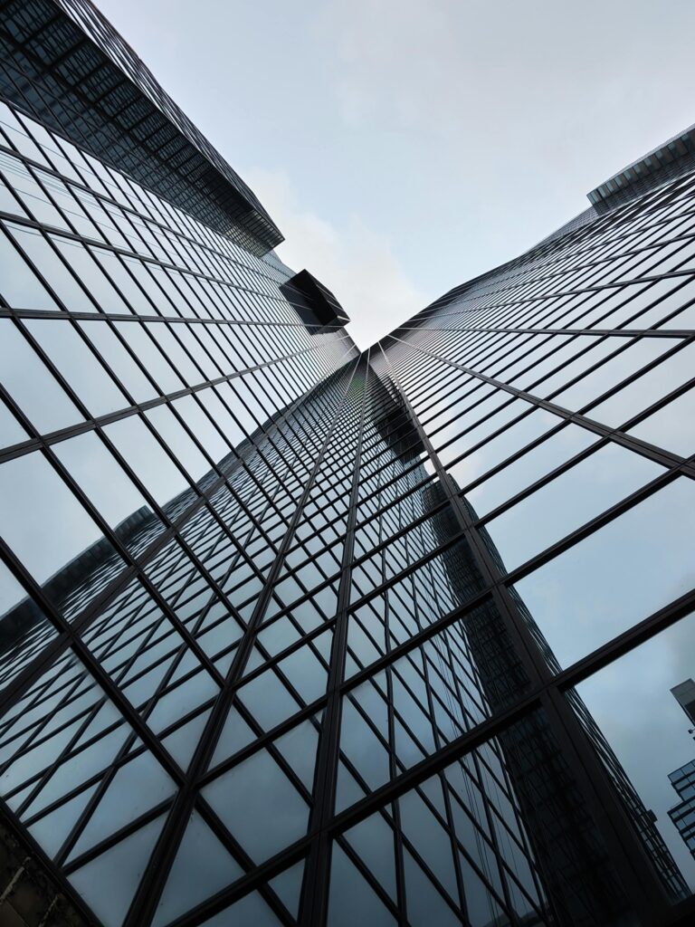 Dramatic upward view of a mirrored skyscraper in Hong Kong